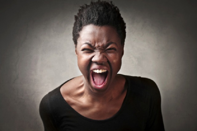 Angry black african American woman shouting with anger
