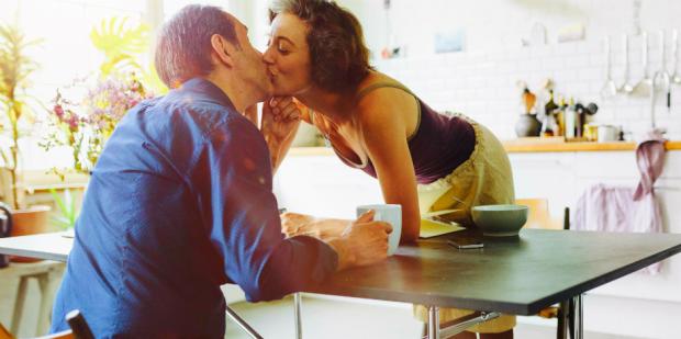 couple kissing at breakfast