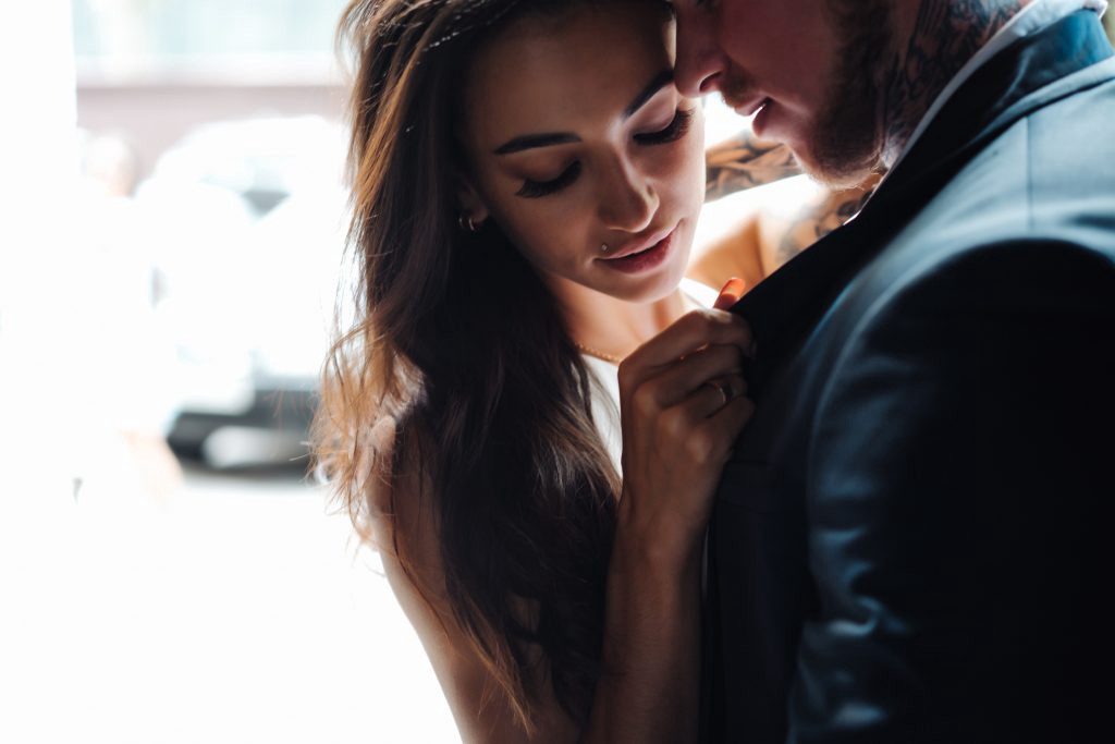 Girl with attractive man in suit about to kiss